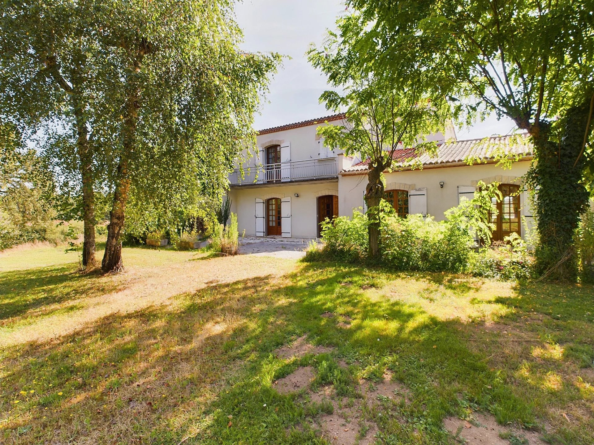 House between town and country in a lush green setting