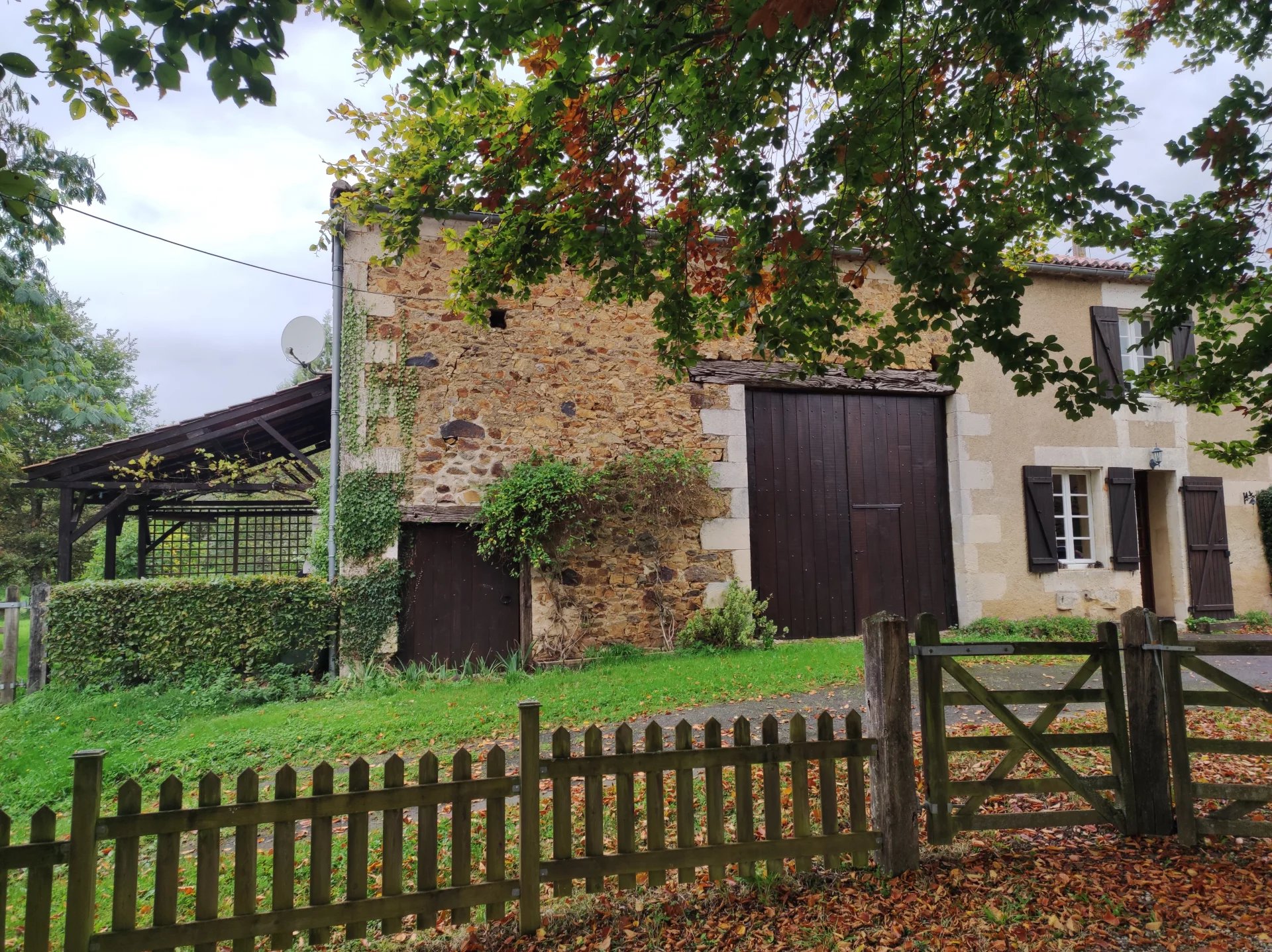 Pretty stone cottage with attached barn, gardens and land of over 8 acres