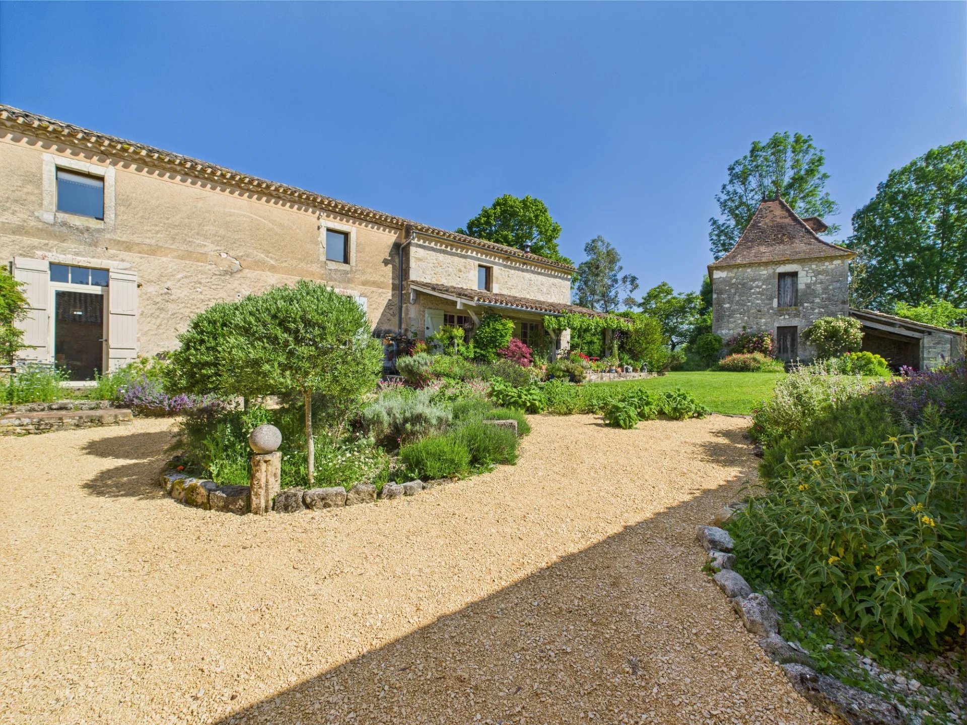Charming house and outbuildings surrounded by a lush garden