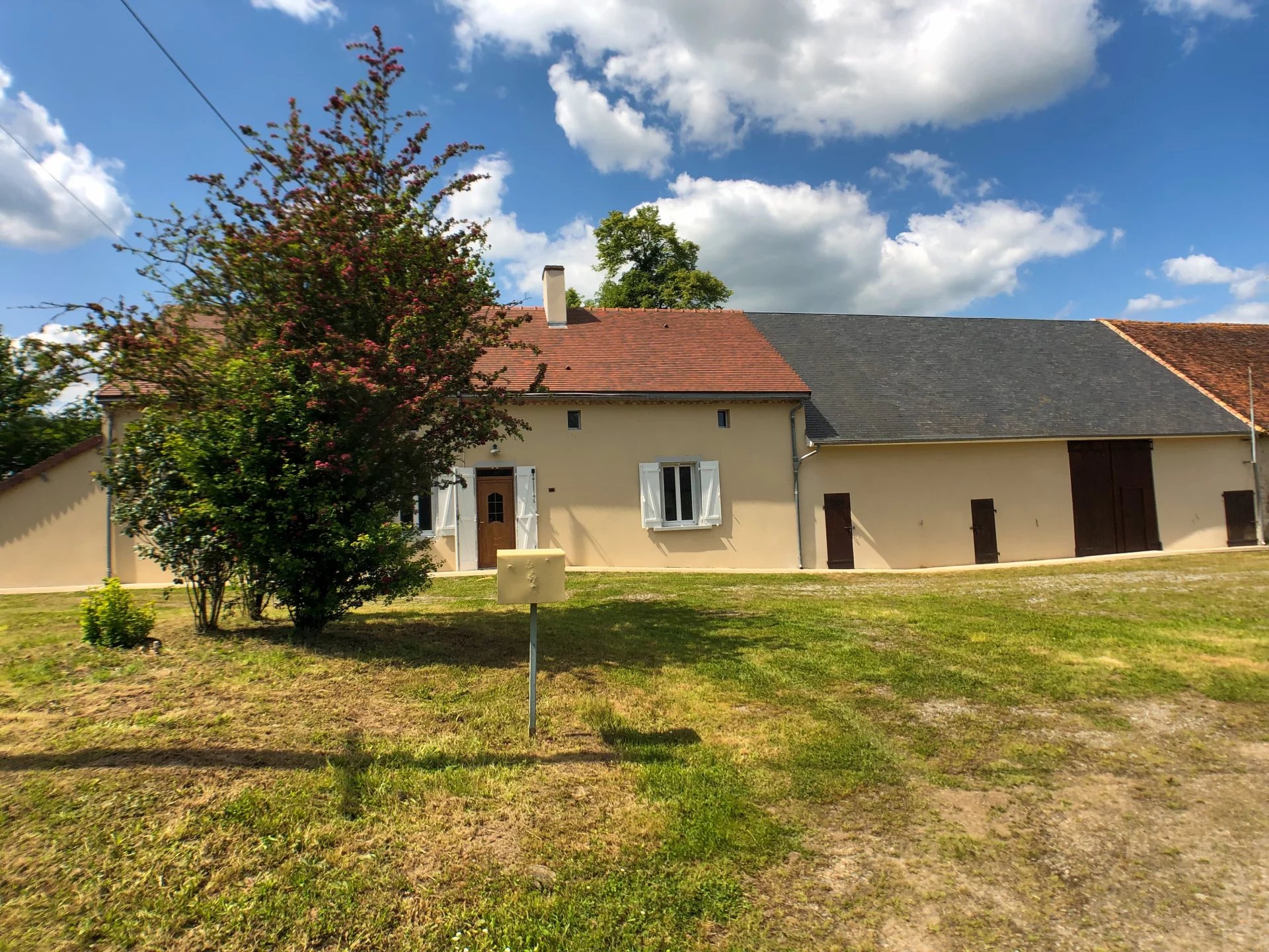 A three bedroom house with a large barn and garden