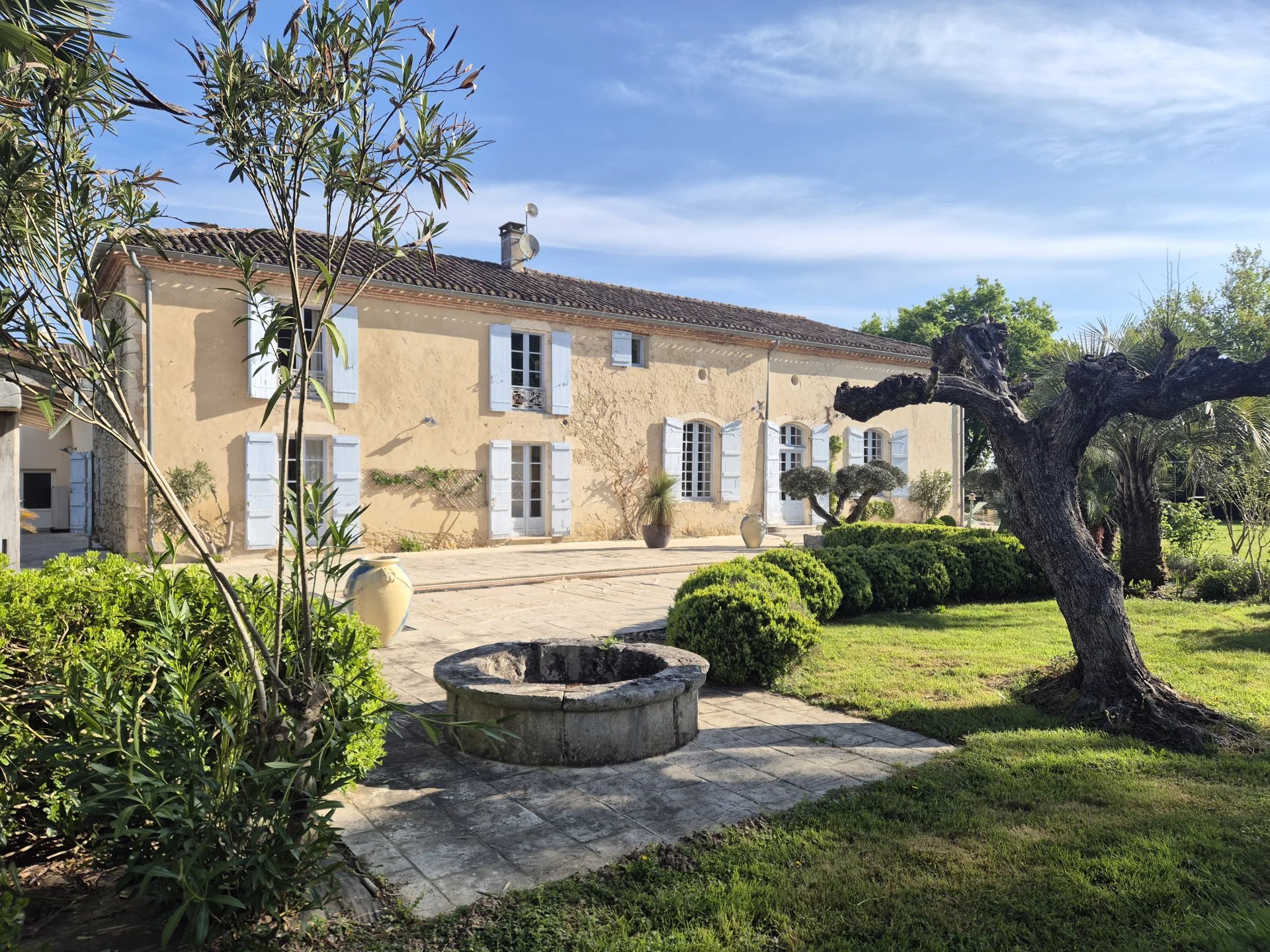 Formal stone house with pool and outbuildings