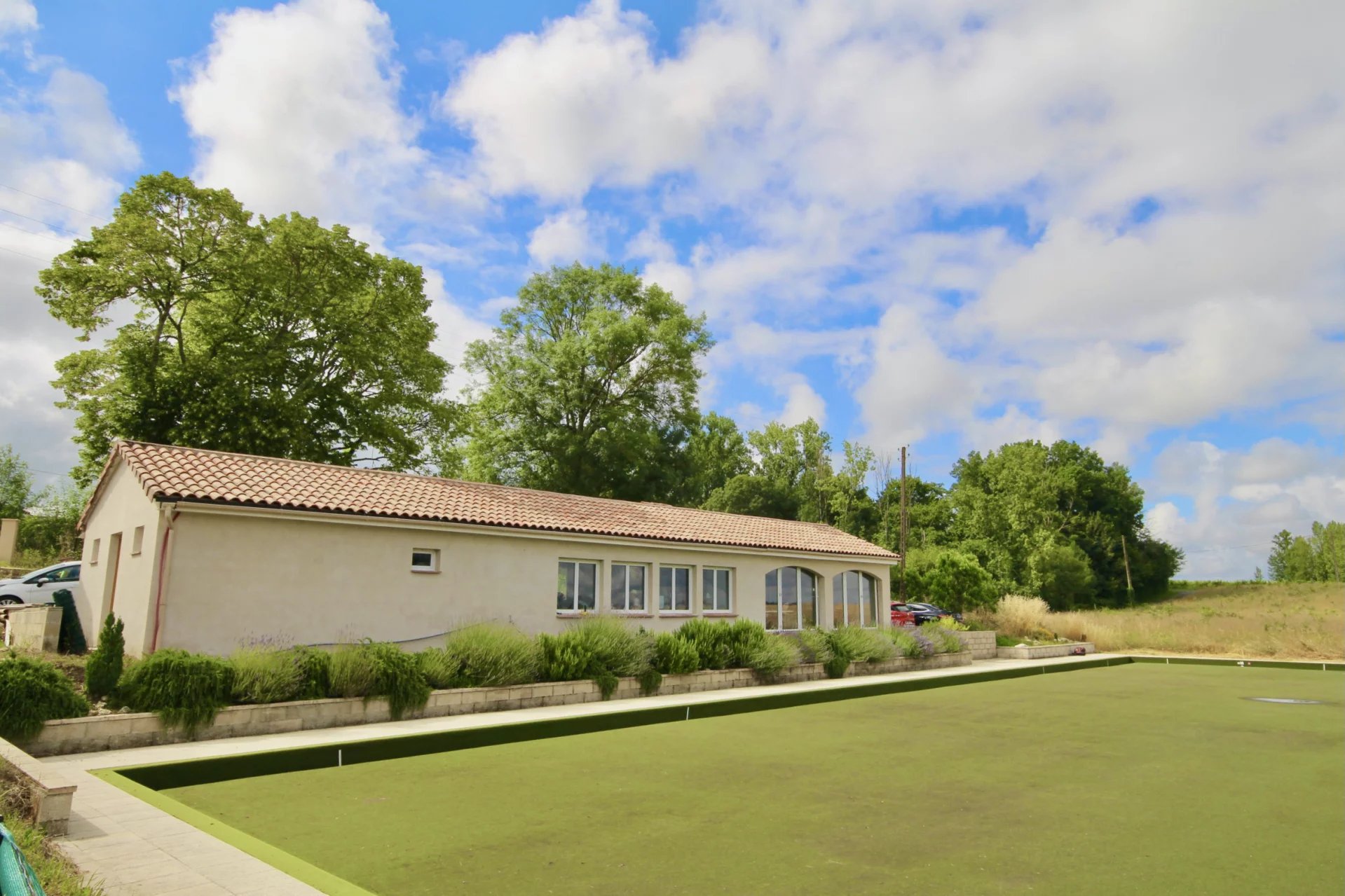 A stone house with a bowling green, club house and 2 gites close to a popular town