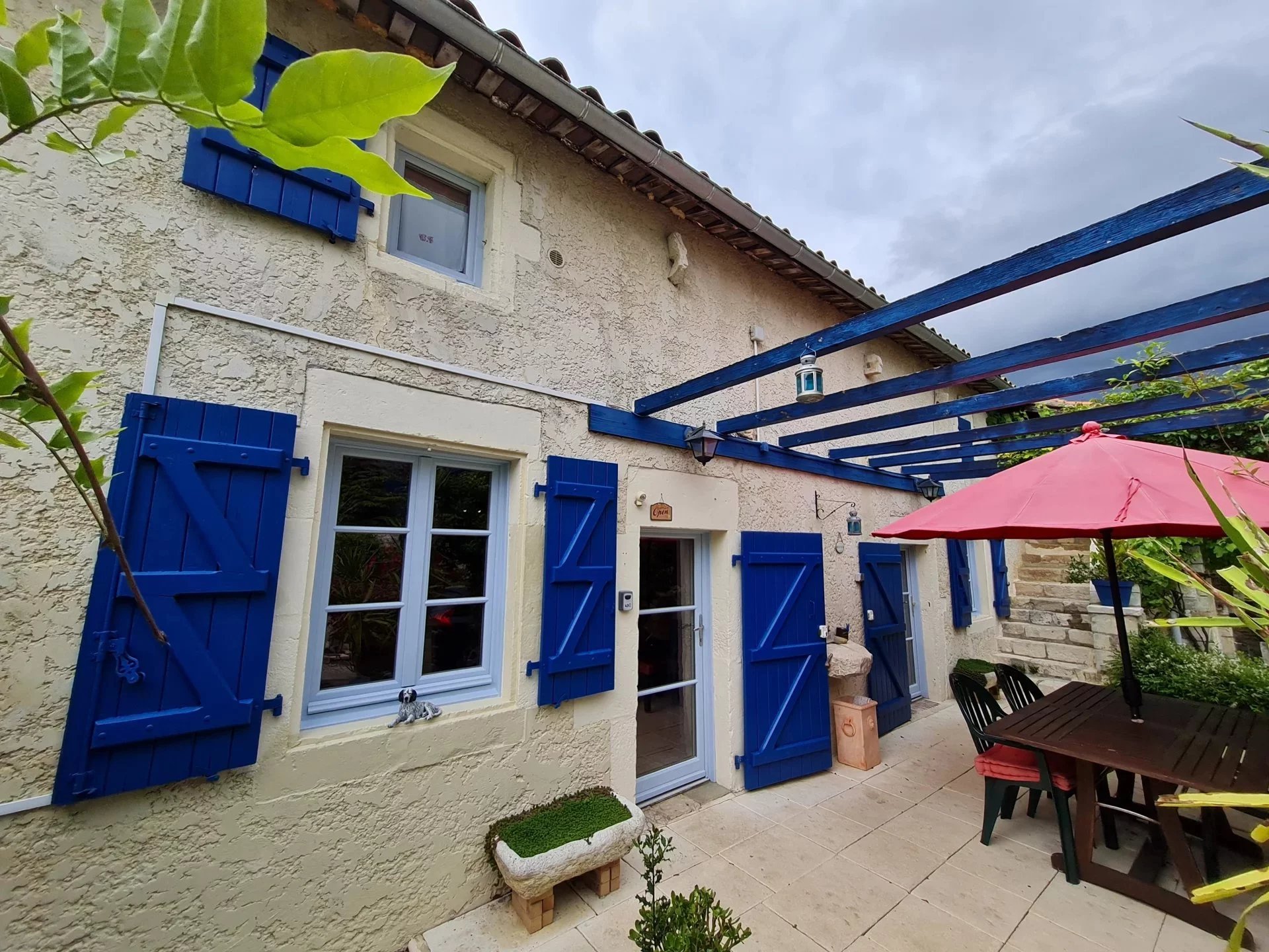 Traditional stone village house with outbuildings and walled garden