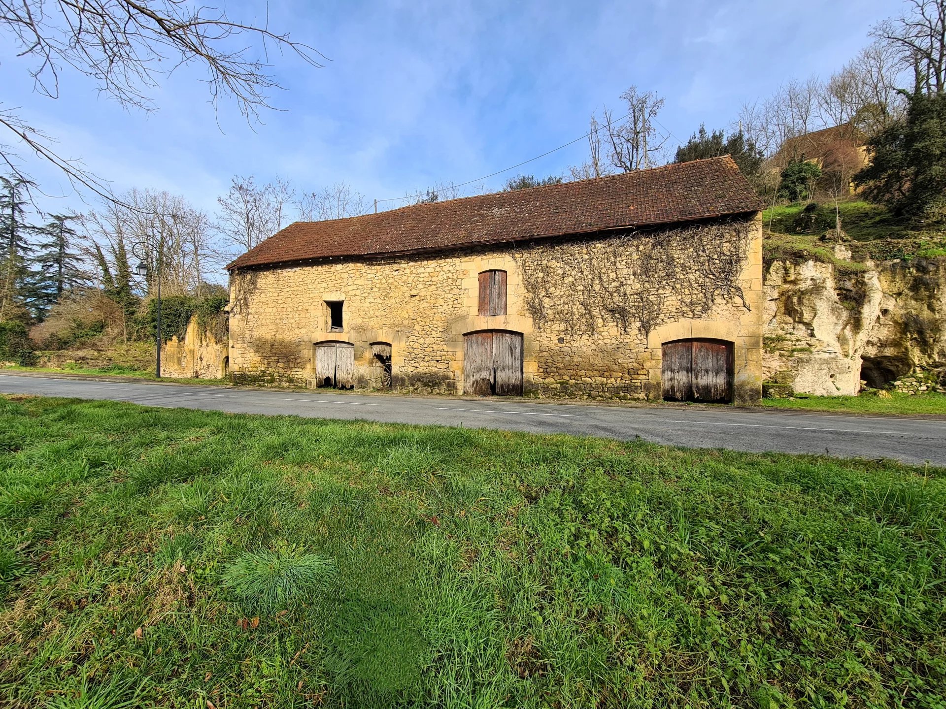 Charming stone barn with ruin, land and cave.