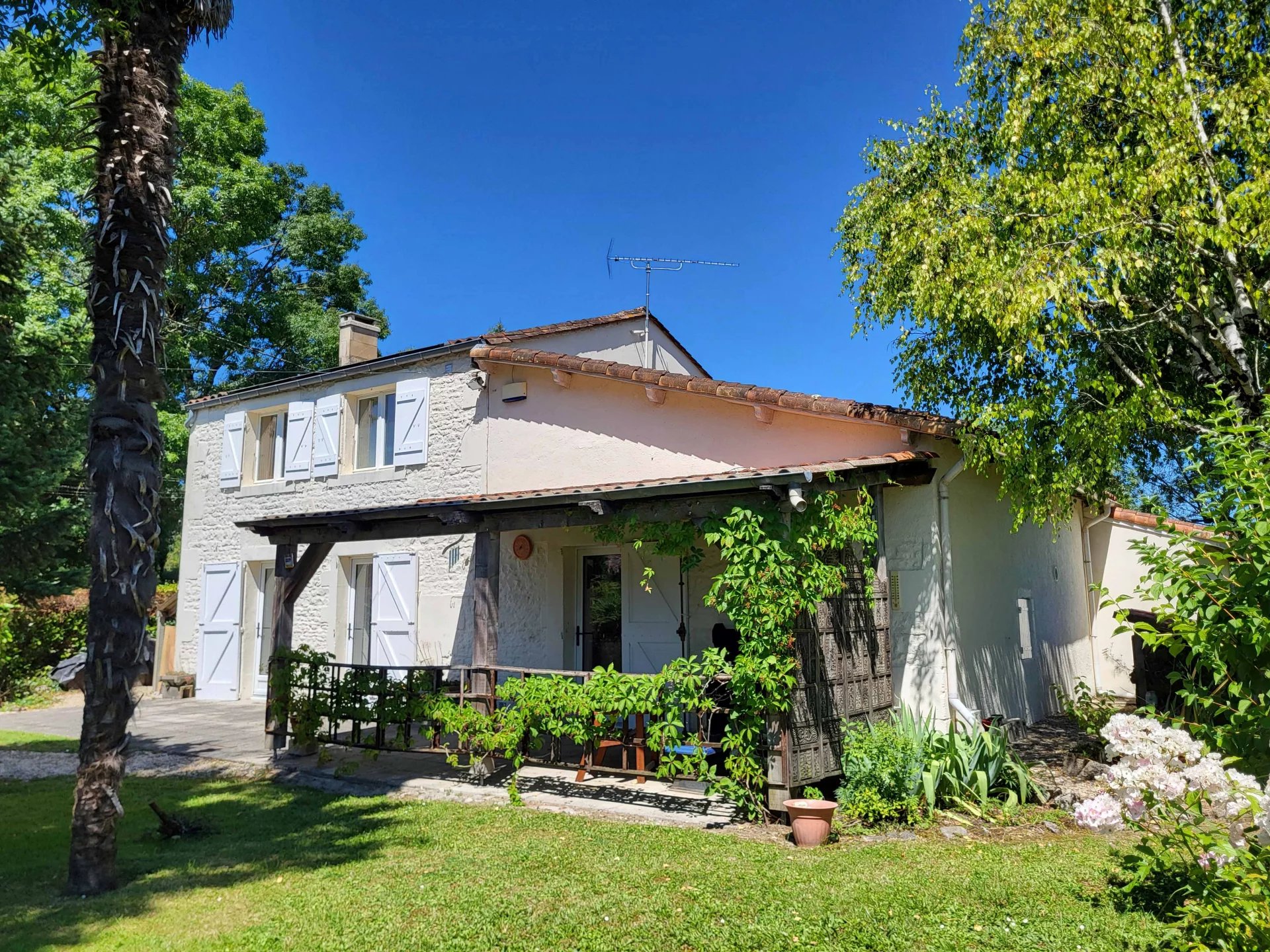 Detached stone village house with enclosed garden, garages and solar-panels